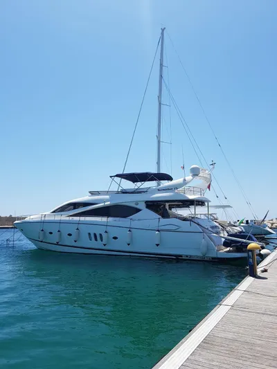 Tais Octavia Yacht Photos Pics Luxury 2005 Sunseeker 75 yacht docked in a sunny marina.