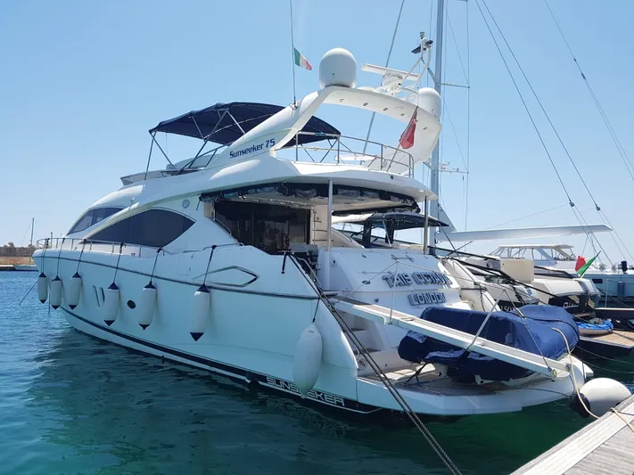 Tais Octavia Yacht Photos Pics Luxury 2005 Sunseeker 75 yacht docked in marina, featuring sleek design and spacious deck.