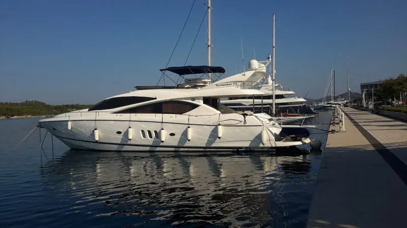 Tais Octavia Yacht Photos Pics 2005 Sunseeker 75 yacht docked at a marina under clear blue skies.