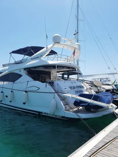 Tais Octavia Yacht Photos Pics 2005 Sunseeker 75 yacht docked at marina, featuring sleek design and spacious deck.