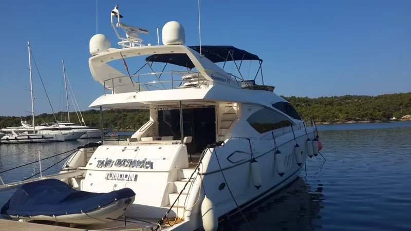 Tais Octavia Yacht Photos Pics Luxury Sunseeker 75 yacht docked at marina, 2005 model, clear blue sky.