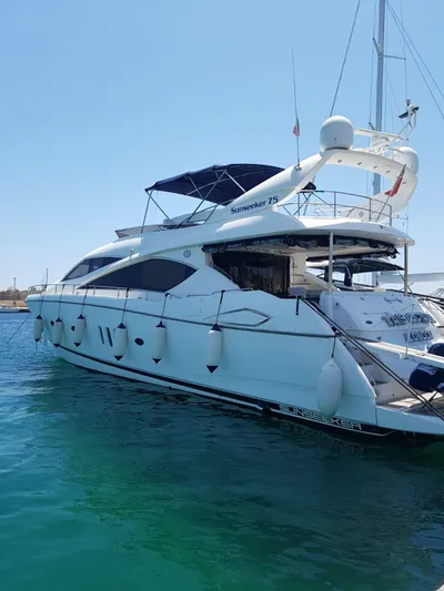 Tais Octavia Yacht Photos Pics Luxury 2005 Sunseeker 75 yacht docked in clear blue water.