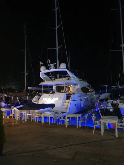 Tais Octavia Yacht Photos Pics 2005 Sunseeker 75 yacht docked at night with blue lighting.