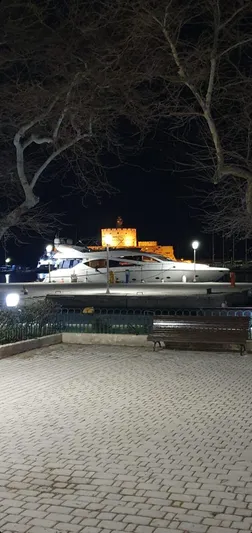 Tais Octavia Yacht Photos Pics Sunseeker 75 yacht docked at night, 2005 model, with illuminated building in background.