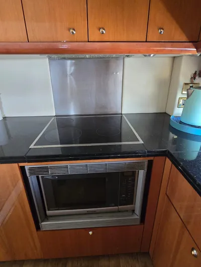 Tais Octavia Yacht Photos Pics Kitchen area in a 2005 Sunseeker 75 yacht with stove and microwave.