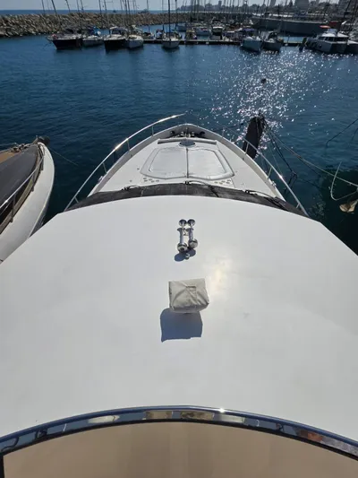 Tais Octavia Yacht Photos Pics Sunseeker 75 yacht (2005) docked in marina, sunny day, calm water.