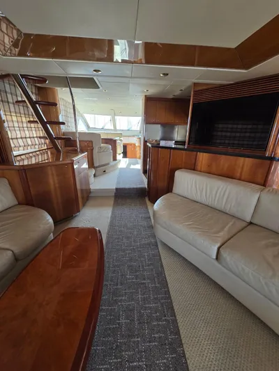 Tais Octavia Yacht Photos Pics Luxurious interior of a 2005 Sunseeker 75 yacht with elegant wood finishes and plush seating.