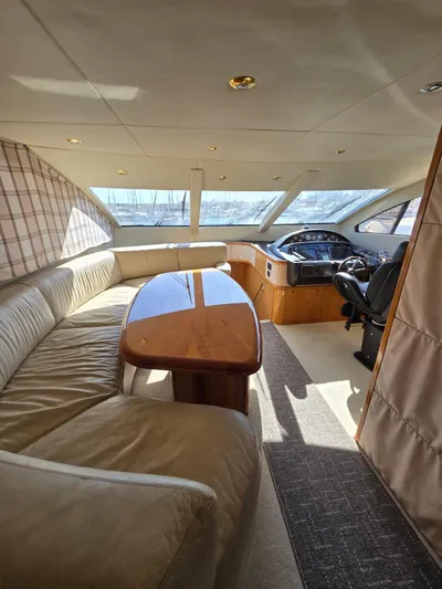 Tais Octavia Yacht Photos Pics Luxurious interior of a 2005 Sunseeker 75 yacht with plush seating and elegant wood finishes.