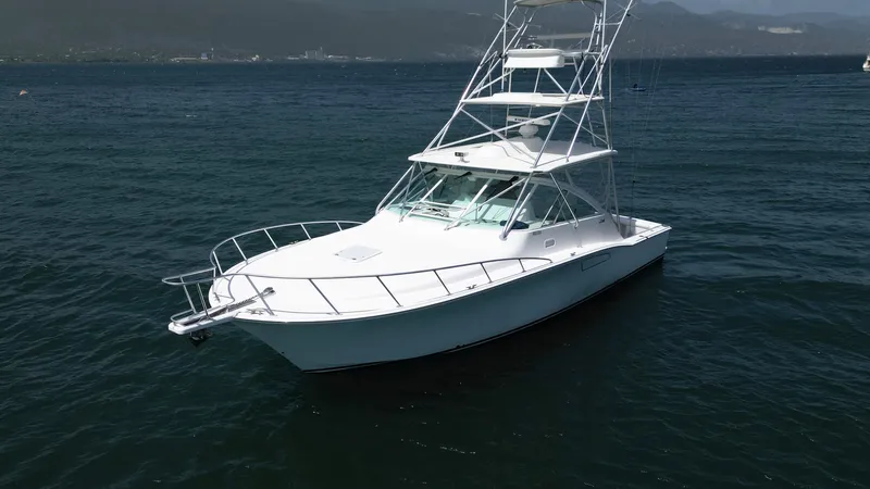 Feeva Yacht Photos Pics 2007 Cabo 40 Hardtop Express boat on calm water with mountainous background.