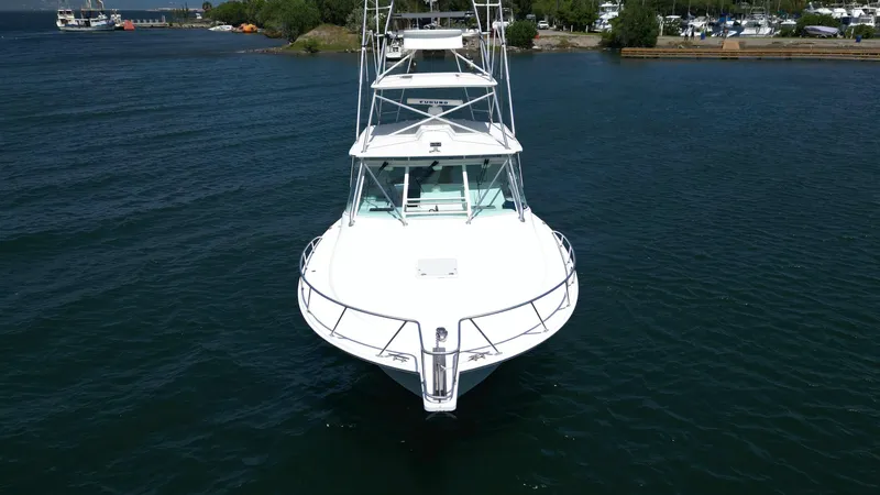 Feeva Yacht Photos Pics 2007 Cabo 40 Hardtop Express boat on calm water, front view.