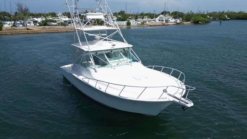 Feeva Yacht Photos Pics 2007 Cabo 40 Hardtop Express yacht on calm water, featuring sleek design and spacious deck.