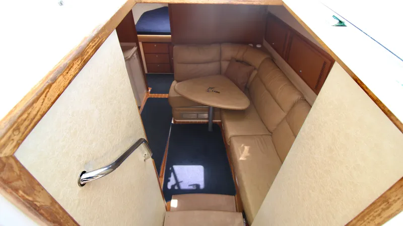 Feeva Yacht Photos Pics Interior of 2007 Cabo 40 Hardtop Express with beige seating and wooden accents.