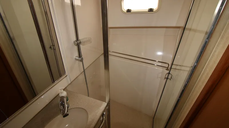 Feeva Yacht Photos Pics 2007 Cabo 40 Hardtop Express bathroom with shower, sink, and window.