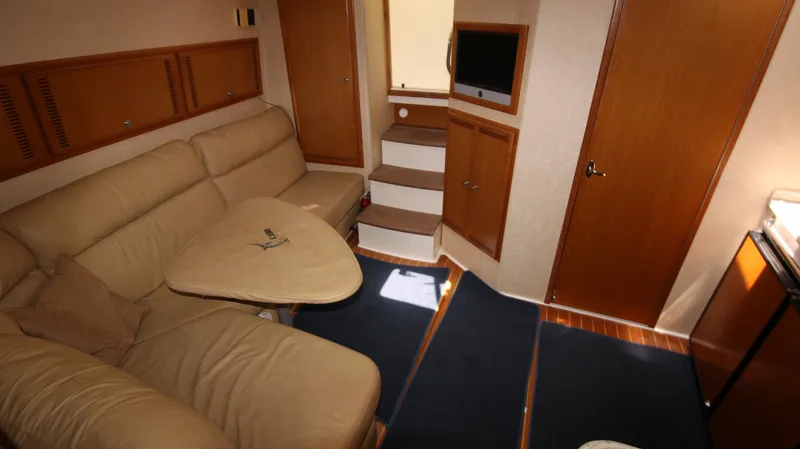 Feeva Yacht Photos Pics Interior of 2007 Cabo 40 Hardtop Express with beige seating and compact design.