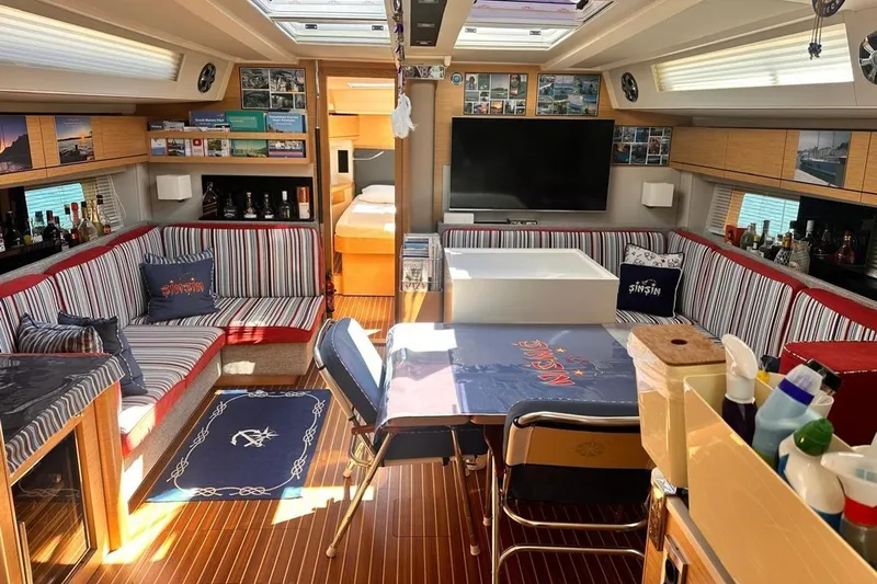  Yacht Photos Pics Luxurious interior of 2018 Hanse 548 yacht with striped seating and modern amenities.