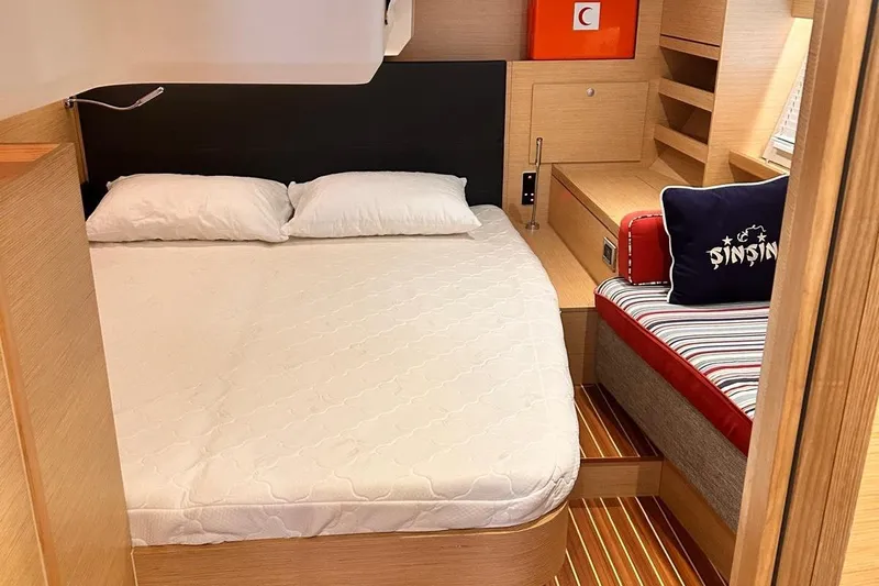  Yacht Photos Pics Luxurious cabin interior of 2018 Hanse 548 yacht with cozy bed and seating area.