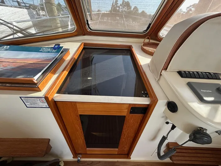 Freedom Yacht Photos Pics Interior of a 2008 Legacy 32 boat with wooden cabinetry and navigation equipment.
