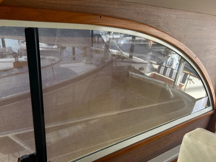 Freedom Yacht Photos Pics Interior view of a 2008 Legacy 32 boat, featuring a screened window and wooden trim.
