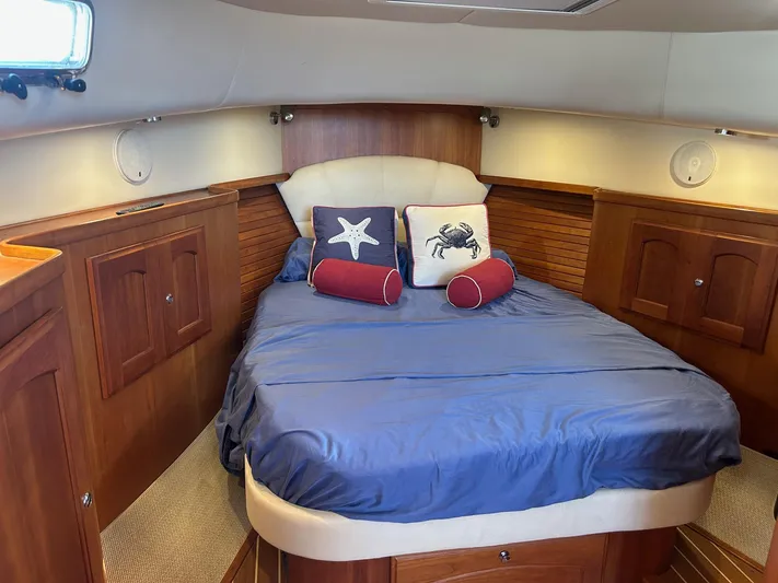 Freedom Yacht Photos Pics Cozy cabin interior of 2008 Legacy 32 yacht with nautical-themed bedding.
