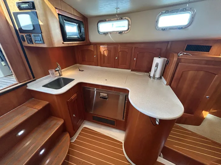 Freedom Yacht Photos Pics Luxurious 2008 Legacy 32 yacht kitchen with wood cabinetry and modern appliances.