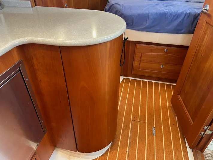 Freedom Yacht Photos Pics Interior of 2008 Legacy 32 boat with wooden cabinetry and flooring.
