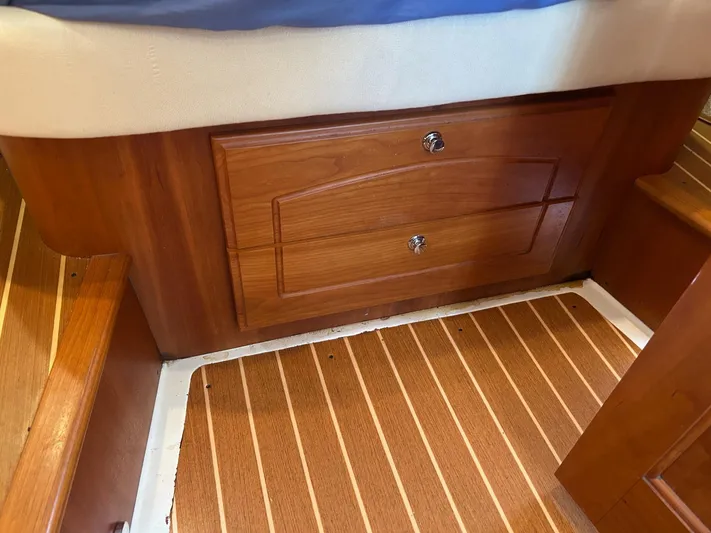 Freedom Yacht Photos Pics Wooden interior of 2008 Legacy 32 boat with drawers and striped flooring.