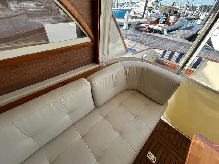 Freedom Yacht Photos Pics Luxurious interior of 2008 Legacy 32 yacht with white leather seating and marina view.