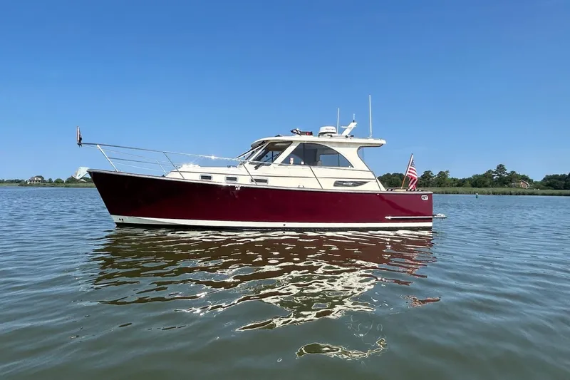 Freedom Yacht Photos Pics 2008 Legacy 32 boat on calm water, clear sky background.
