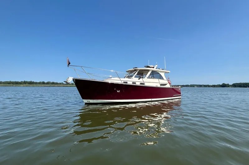 Freedom Yacht Photos Pics 2008 Legacy 32 boat on calm water under clear blue sky.