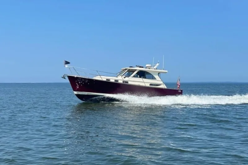 Freedom Yacht Photos Pics 2008 Legacy 32 boat cruising on open water under clear blue sky.