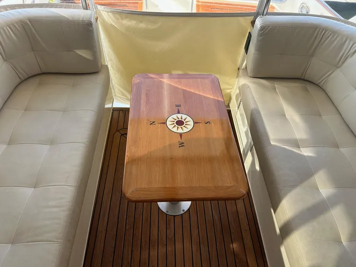 Freedom Yacht Photos Pics Interior of 2008 Legacy 32 boat with compass table and cushioned seating.