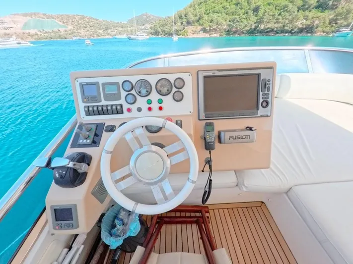  Yacht Photos Pics Helm of 2010 Azimut 64 yacht with steering wheel and navigation controls.