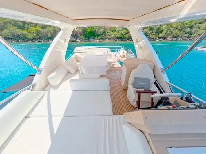  Yacht Photos Pics Luxurious 2010 Azimut 64 yacht interior with plush seating, overlooking serene turquoise waters.