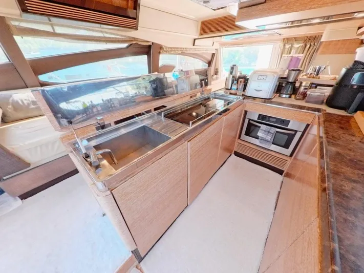  Yacht Photos Pics Luxurious kitchen interior of a 2010 Azimut 64 yacht, featuring modern appliances and sleek design.