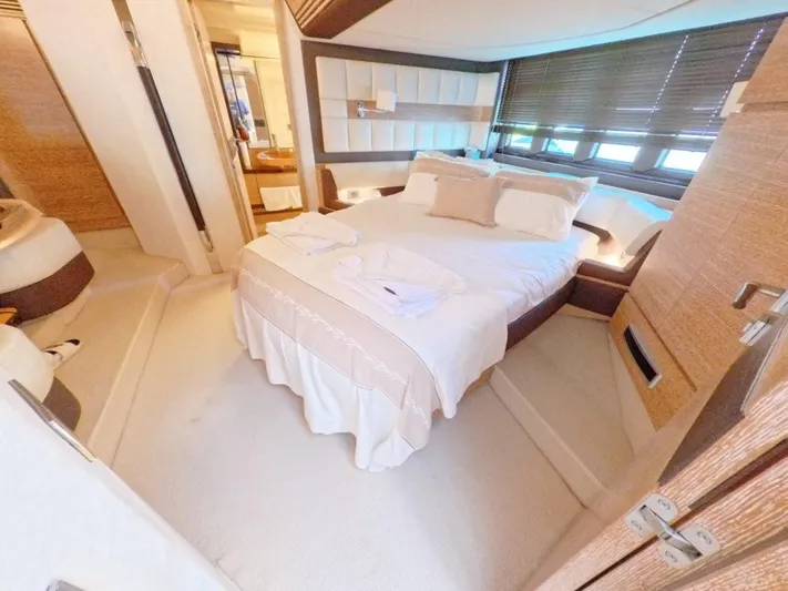  Yacht Photos Pics Luxurious bedroom interior of a 2010 Azimut 64 yacht with elegant bedding and modern design.