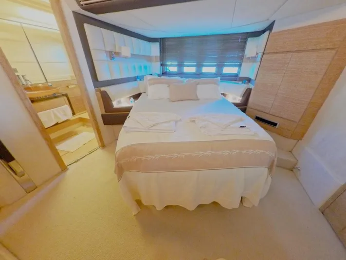  Yacht Photos Pics Luxurious bedroom interior of 2010 Azimut 64 yacht with elegant bedding and ambient lighting.