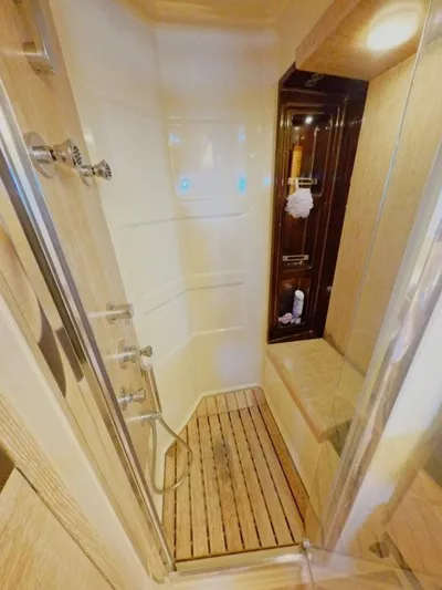  Yacht Photos Pics Luxurious shower in 2010 Azimut 64 yacht with wooden flooring and modern fixtures.