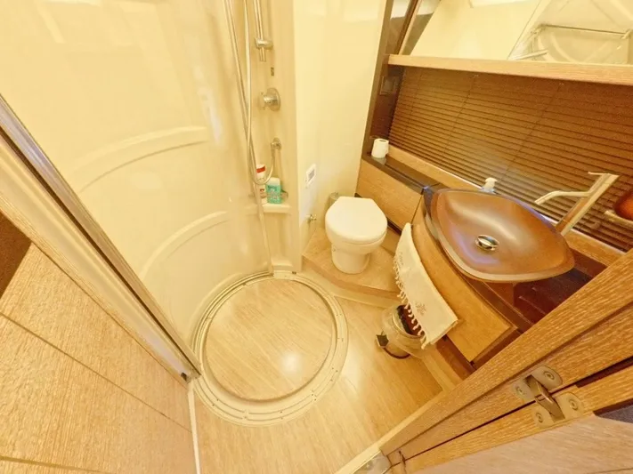  Yacht Photos Pics Luxurious bathroom in 2010 Azimut 64 yacht with modern fixtures and wooden accents.