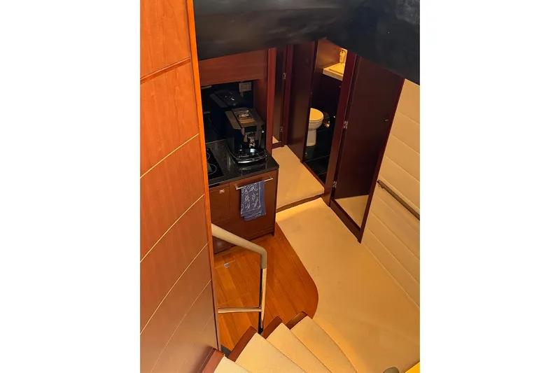  Yacht Photos Pics Staircase leading to a compact kitchen and bathroom in a 2016 Princess S72 yacht.