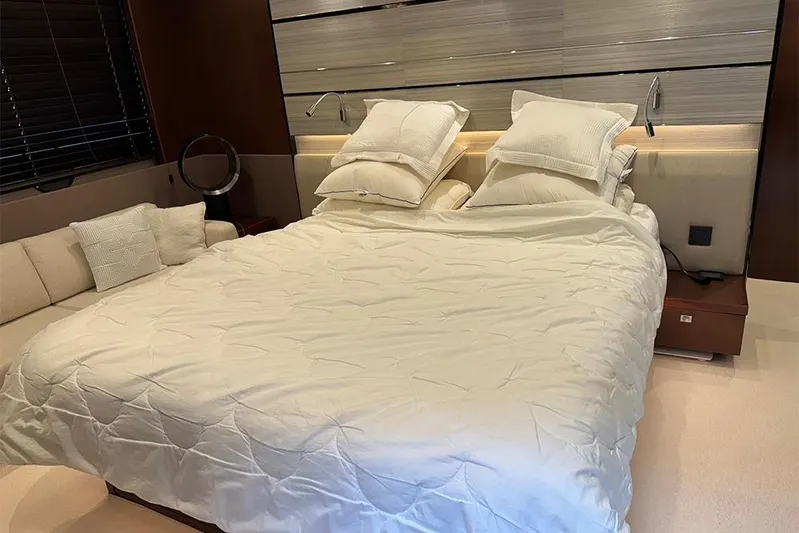  Yacht Photos Pics Luxurious bedroom interior on a 2016 Princess S72 yacht, featuring a cozy bed and modern decor.