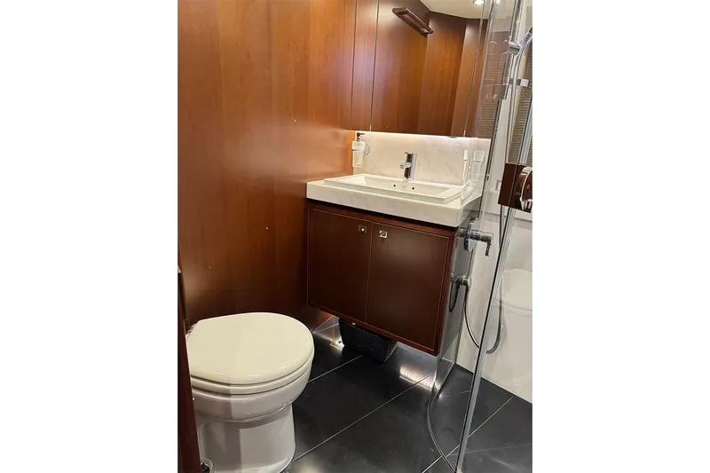  Yacht Photos Pics Luxurious bathroom in 2016 Princess S72 yacht with wood paneling and modern fixtures.