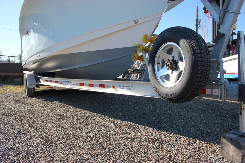  Yacht Photos Pics 2018 Sea Hunt Gamefish 30 on trailer, parked on gravel surface.