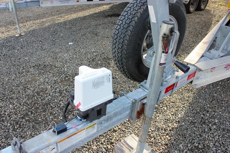  Yacht Photos Pics Trailer hitch and jack stand for 2018 Sea Hunt Gamefish 30 on gravel surface.