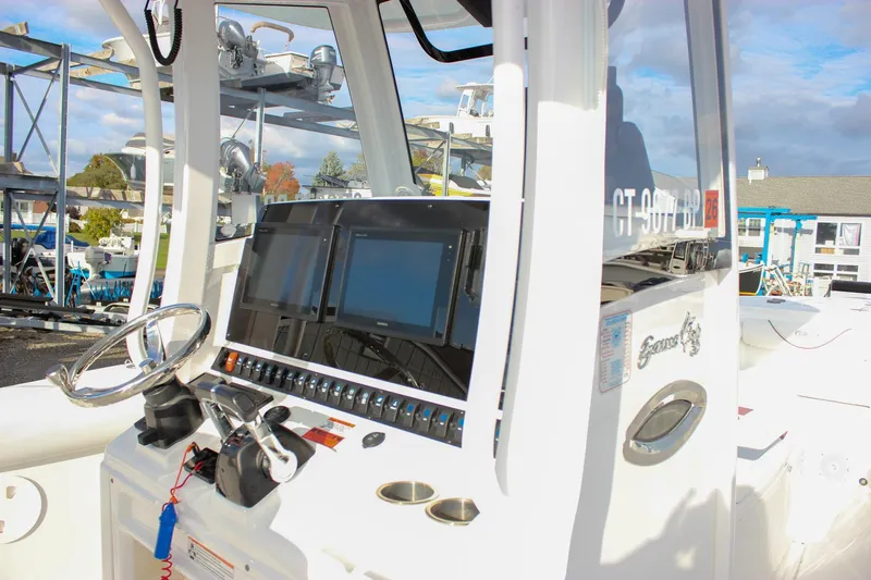  Yacht Photos Pics 2018 Sea Hunt Gamefish 30 boat dashboard with steering wheel and navigation screens.