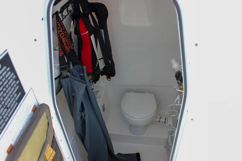  Yacht Photos Pics 2018 Sea Hunt Gamefish 30 boat interior with toilet and hanging gear.