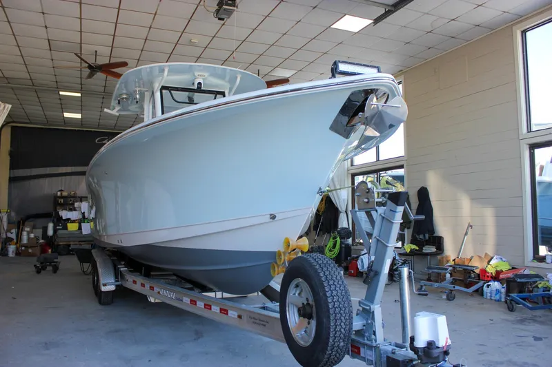  Yacht Photos Pics 2018 Sea Hunt Gamefish 30 boat on trailer in a garage setting.