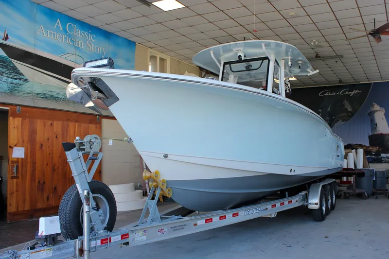  Yacht Photos Pics 2018 Sea Hunt Gamefish 30 boat on trailer in showroom setting.