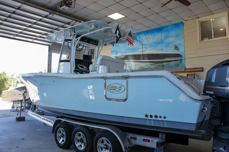  Yacht Photos Pics 2018 Sea Hunt Gamefish 30 boat on trailer in garage setting.