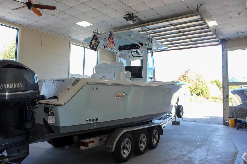  Yacht Photos Pics 2018 Sea Hunt Gamefish 30 boat on trailer in garage with Yamaha engine.