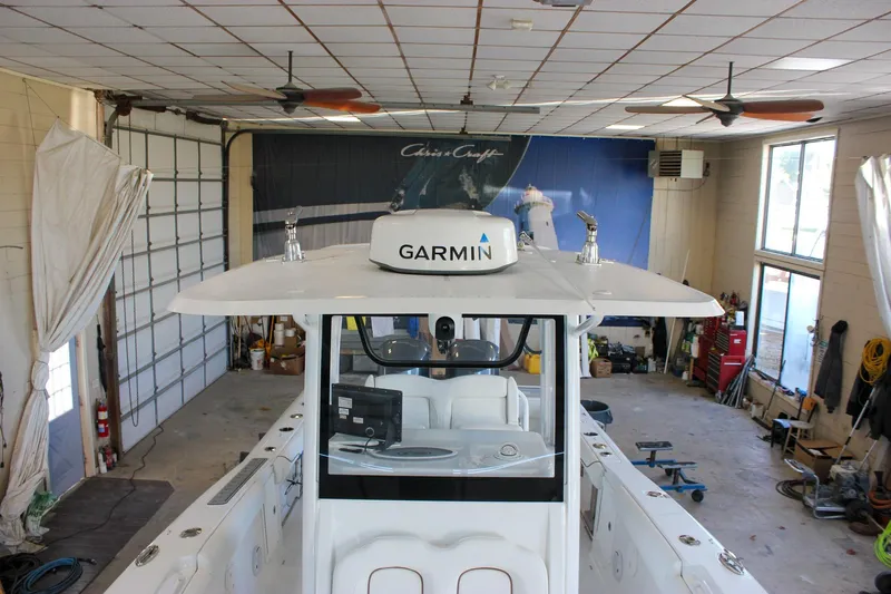  Yacht Photos Pics 2018 Sea Hunt Gamefish 30 boat in a garage with Garmin equipment.